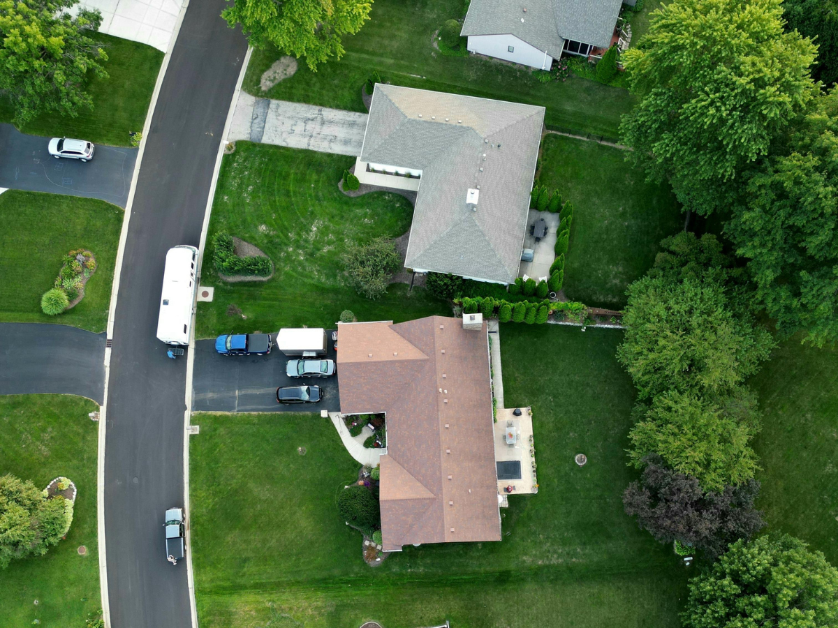 A home with a new dark shingle hip roof, shown from above.