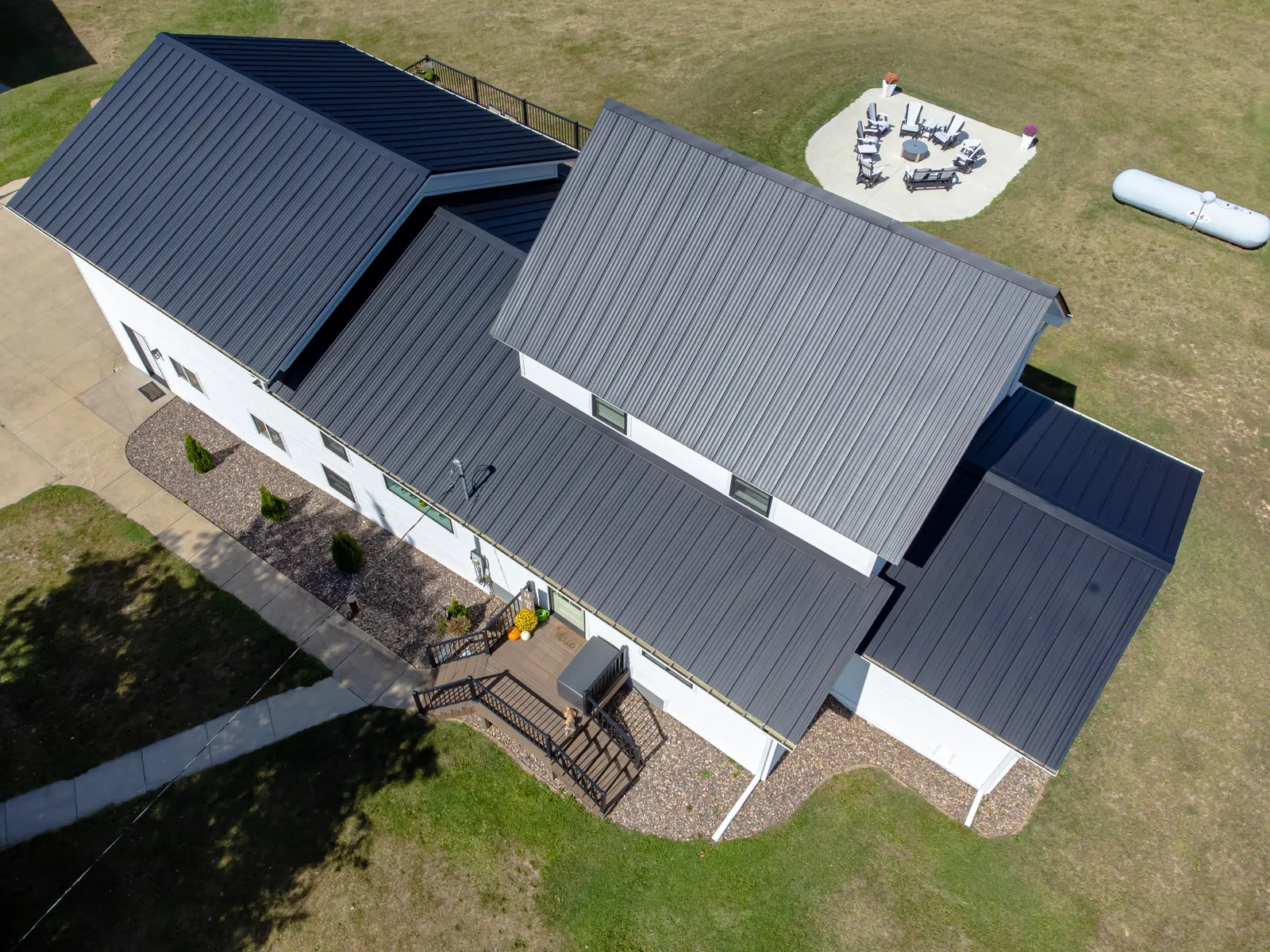 Aerial view of a dark standing seam metal roof on a country home