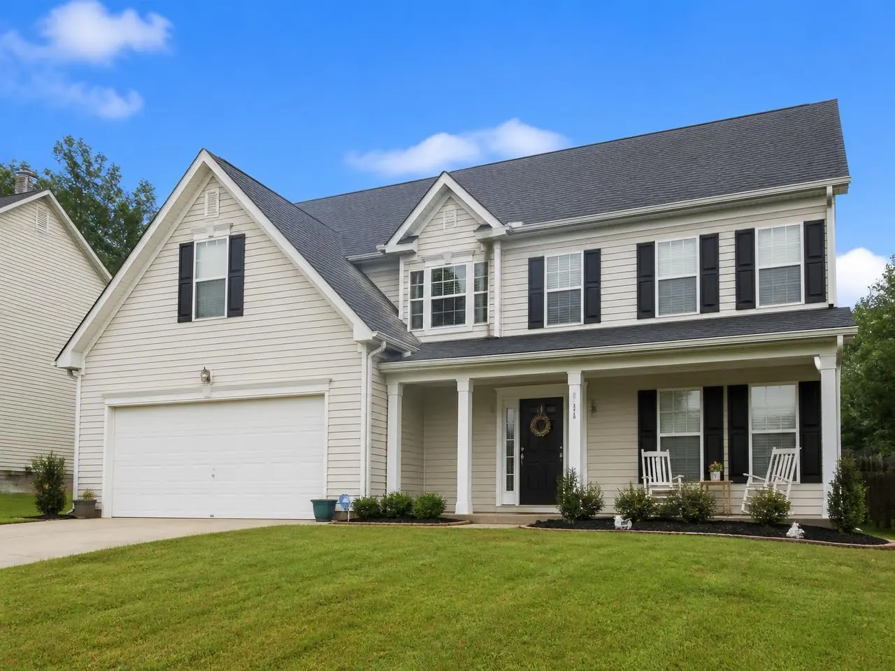 Holly Springs, GA home with a new shingle roof after storm damage restoration